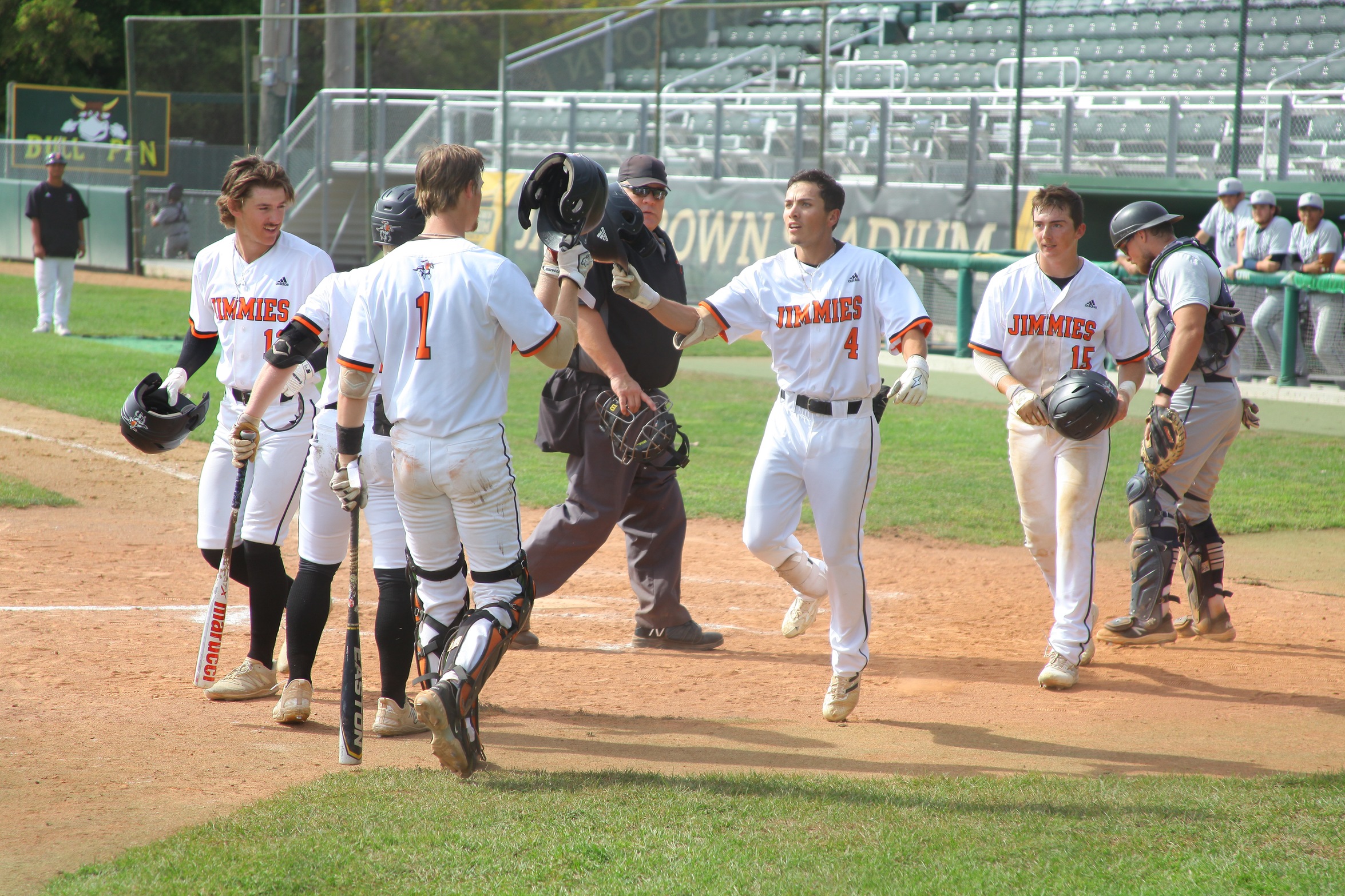 The Jimmies' Alex Alva (4) is congratulated by teammates after hitting a three-run home run in UJ's 5-0 game one victory over Dickinson State Thursday/Photo by Molly Dockter, UJ Sports Information