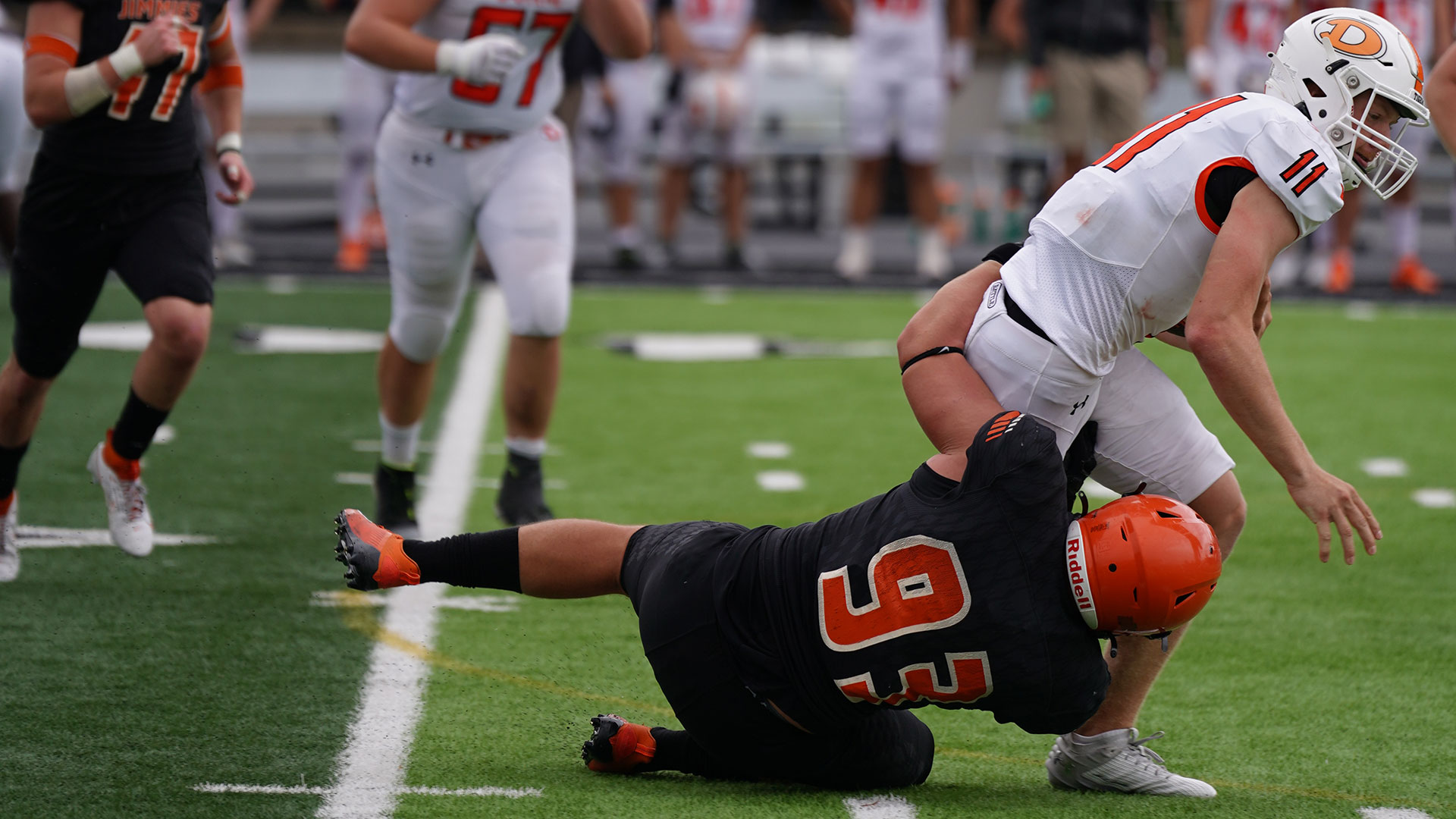 The Jimmies' Tyler Dean (93) records one of his three sacks in Saturday's 10-7 win over Doane (Neb.) / Photo by Alex Maida