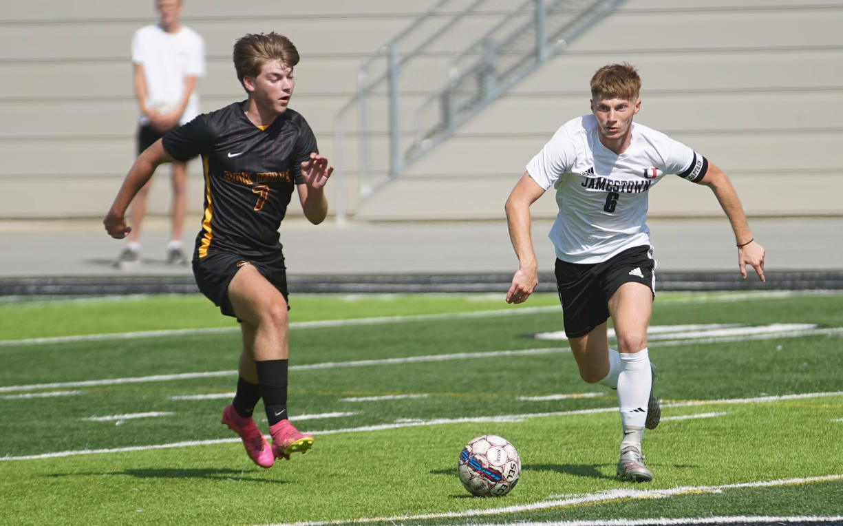 UJ's Jacob Holtz dribbles past Holter Robinson of Oak Hills Christian College in Friday's 6-0 win / Photo by Alex Maida